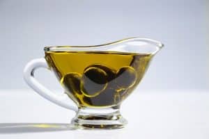 Diferencia entre AOVE y aceite de oliva. Taza con aceite de oliva